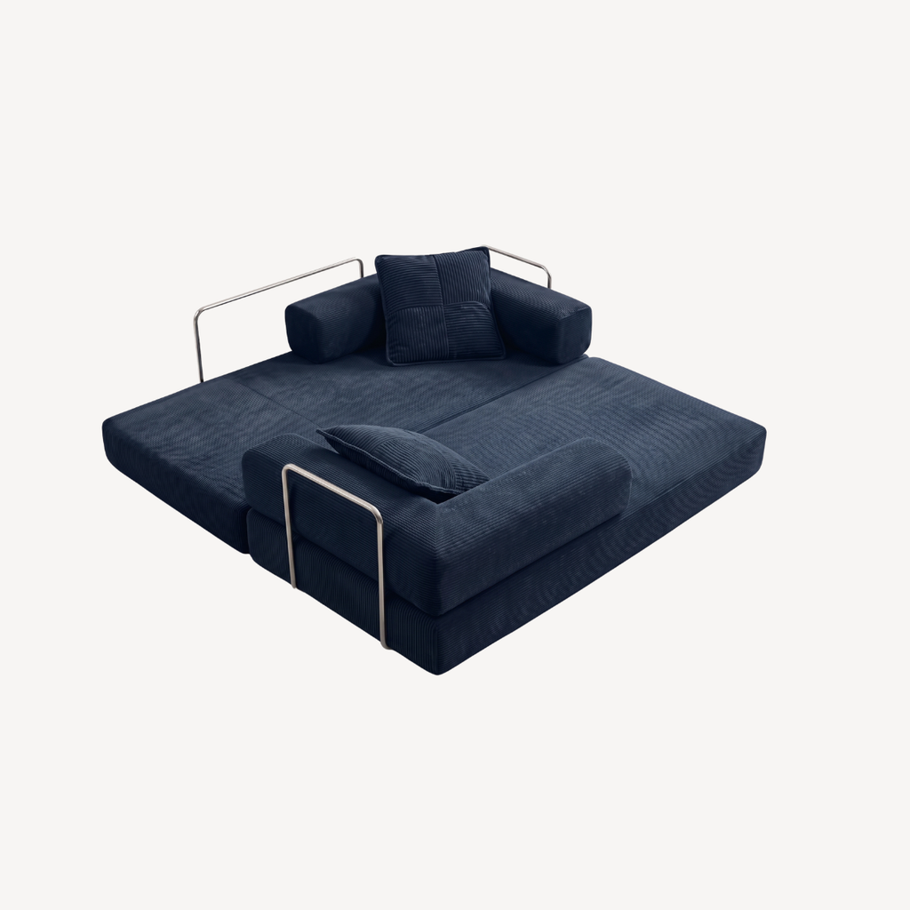 Canapé convertible bleu foncé en velours côtelé, assise dépliée et coussins.