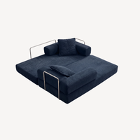 Canapé convertible bleu foncé en velours côtelé, assise dépliée et coussins.