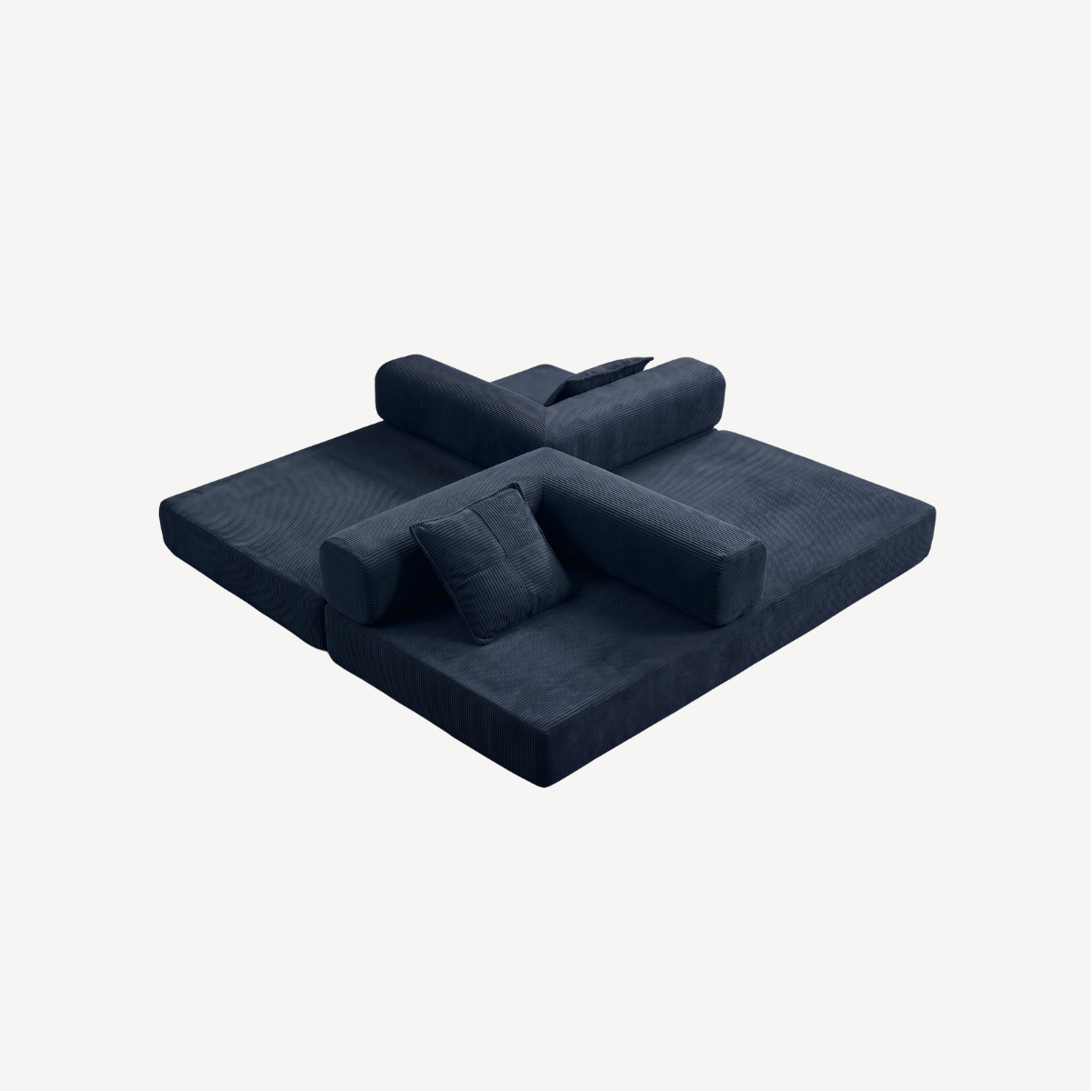 Canapé convertible bleu foncé en velours côtelé, couchage étendu, coussins empilés.