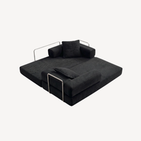 Canapé 2 places modulable velours côtelé noir, configuration couchage avec dossier relevé.