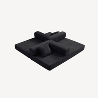 Canapé 2 places modulable velours côtelé noir, assise étendue en position lit.