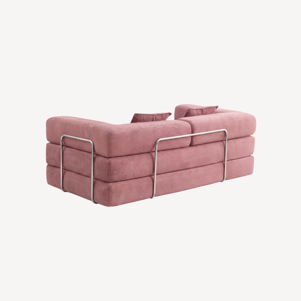 Canapé rose en velours côtelé, structure avec barres métalliques et coussins d’assise