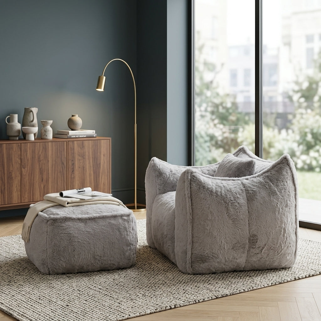 Fauteuil en fourrure gris clair avec repose-pied, coussinage épais.