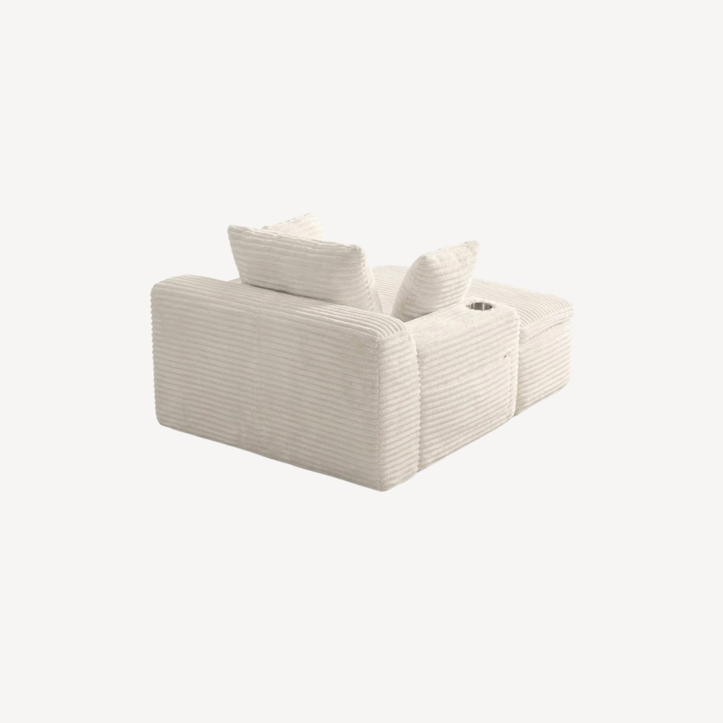 Fauteuil compressé 1 place en velours côtelé écru, accoudoirs et coussins roulés.