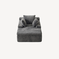Fauteuil compressé 1 place en velours côtelé gris, face avant avec coussins roulés.
