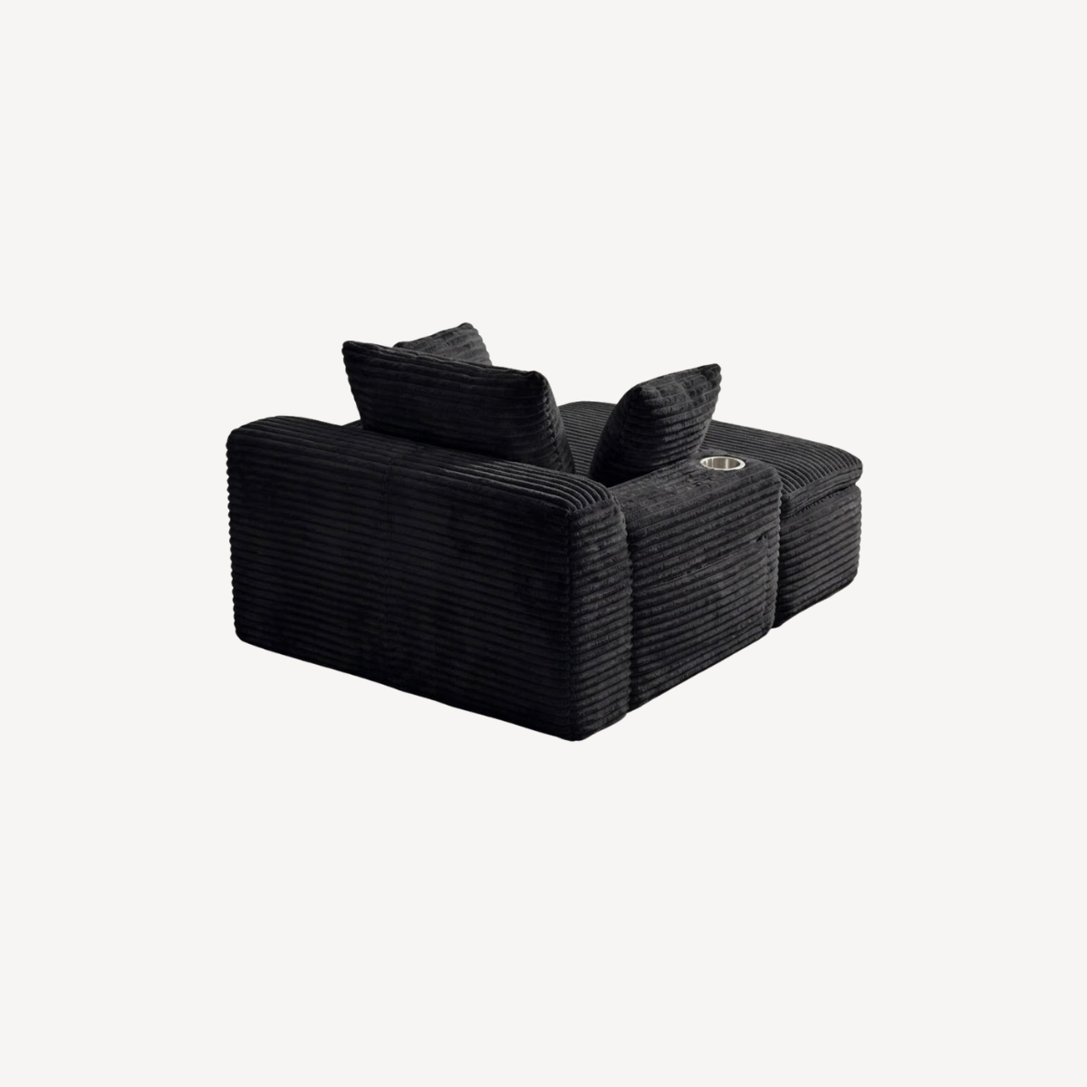 Fauteuil compressé 1 place en velours côtelé noir, vue latérale avec coussins d’appoint.