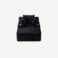 Fauteuil compressé 1 place en velours côtelé noir, face avant avec coussins roulés.