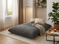Pouf gris en velours côtelé compressé, assise arrondie et dossier rembourré
