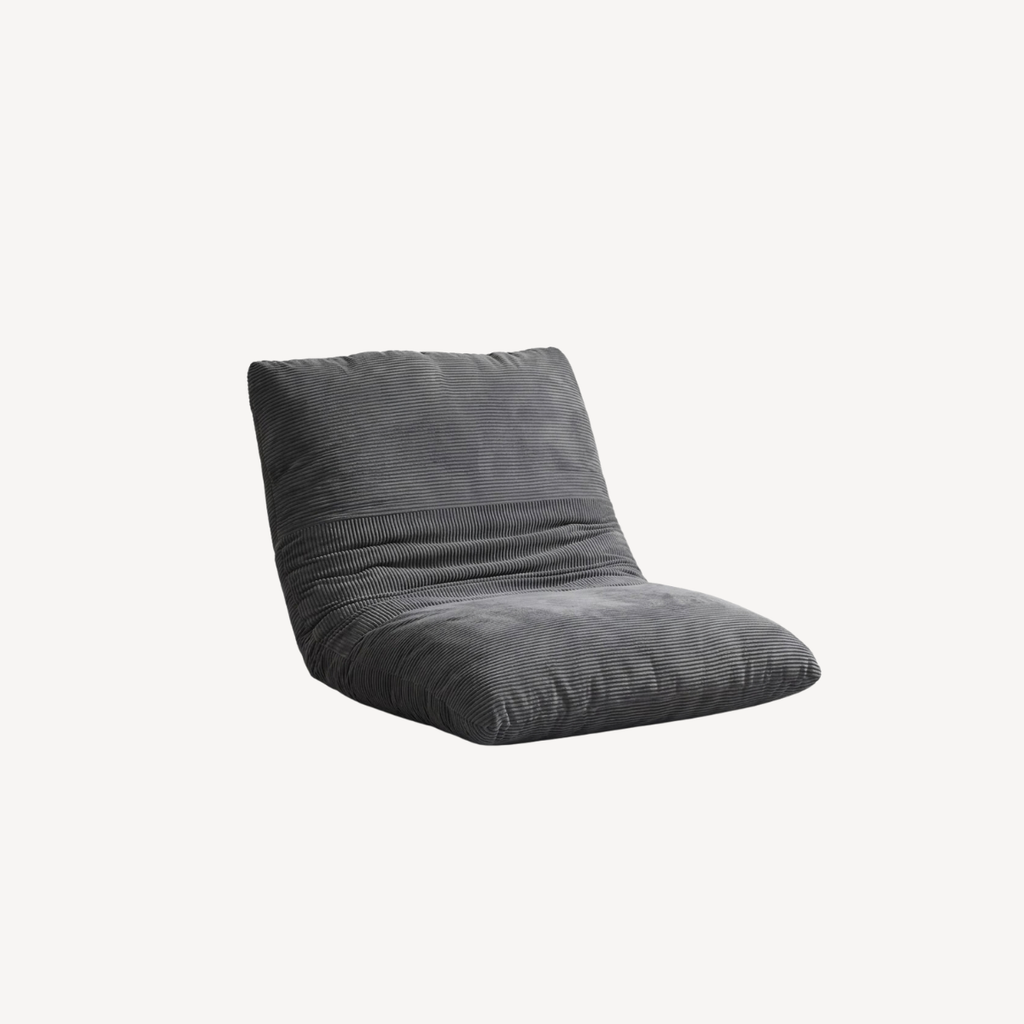 Pouf gris en velours côtelé, vue trois-quarts, dossier haut et côtés arrondis